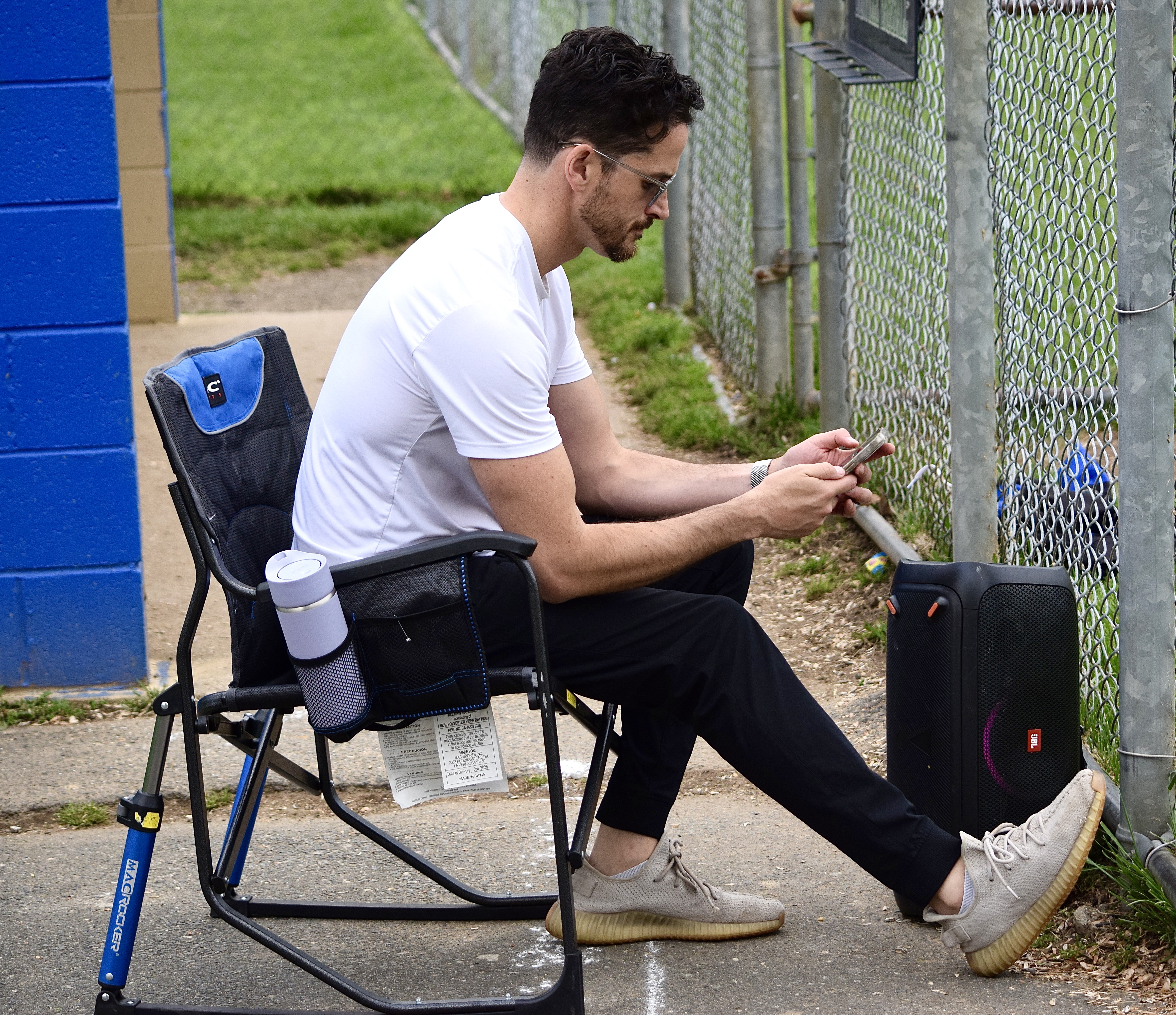 The Chief Hype Officer — lawn chair, phone, speaker at the ready